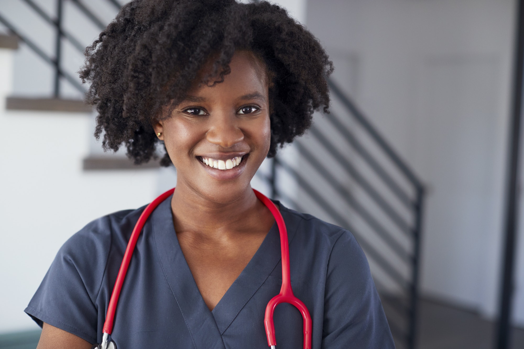 Portrait Of Female Nurse Wearing Scrubs In Hospital